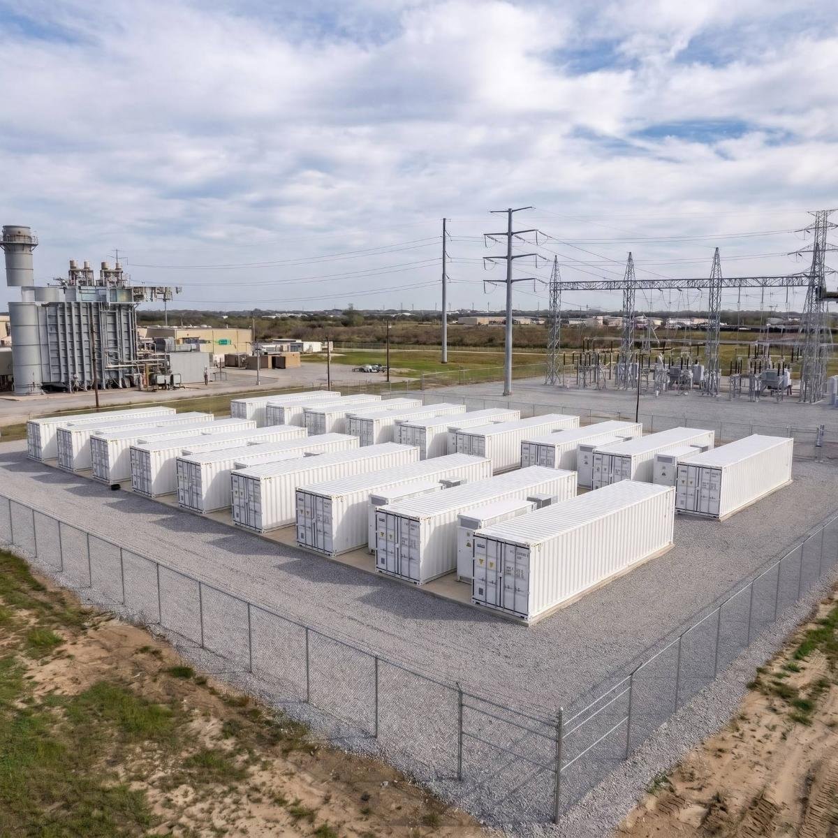 Battery storage containers beside grid infrastructure