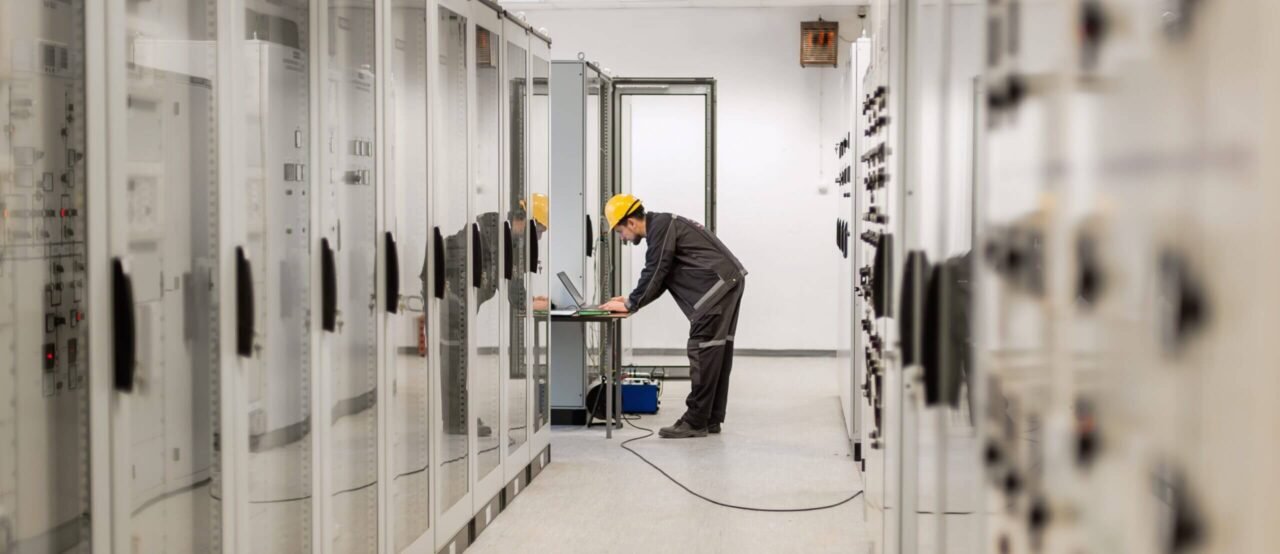 O&M engineer performing testing on switchgear in a data center
