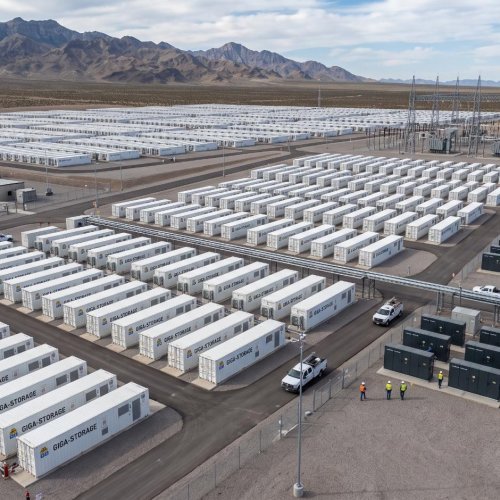 Aerial view of a utility-scale battery energy storage site with rows of containerised battery units, inverters and substation equipment.